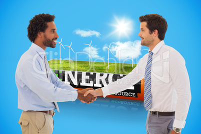 Composite image of smiling young businessmen shaking hands in of