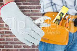 Composite image of technician using pliers over white background