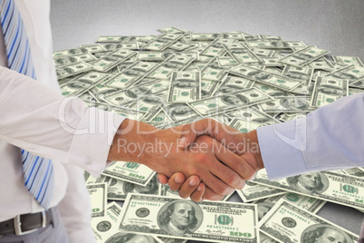 Composite image of close-up shot of a handshake in office