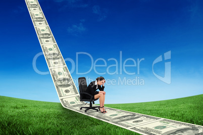Composite image of worried businesswoman on swivel chair