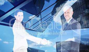 Composite image of smiling business people shaking hands while l