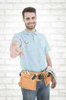 Composite image of smiling construciton worker holding wrench