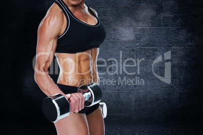 Composite image of female bodybuilder working out with large dum