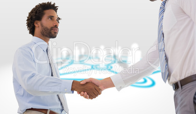 Composite image of young businessmen shaking hands in office