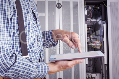 Composite image of geeky businessman using his tablet pc