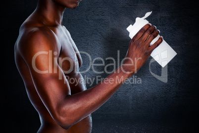Composite image of mid section of a sporty young man holding pro