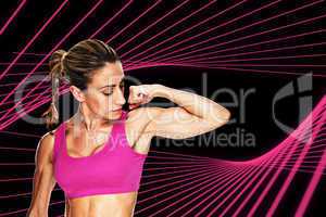Composite image of female bodybuilder flexing bicep in pink spor