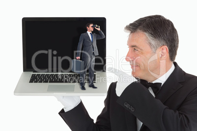 Composite image of businessman looking through binoculars