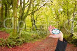 Composite image of businessman holding hand out in presentation