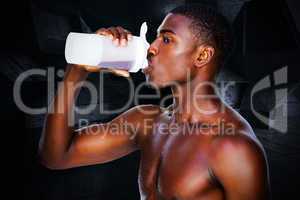 Composite image of side view of a sporty man drinking protein