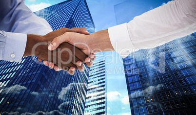 Composite image of close-up shot of a handshake in office