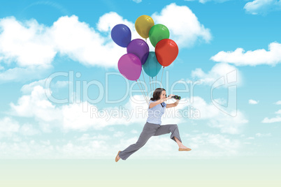 Composite image of cheerful classy businesswoman jumping while h