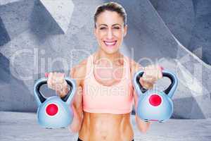 Composite image of smiling female crossfitter lifting kettlebell