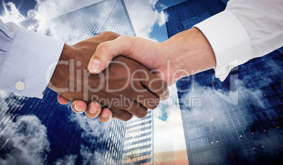 Composite image of close-up shot of a handshake in office