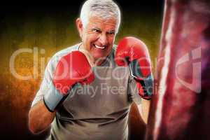 Composite image of portrait of a determined senior boxer