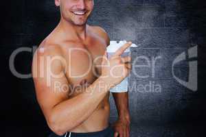 Composite image of bodybuilder holding flask