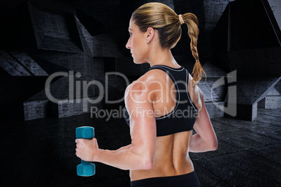 Composite image of female bodybuilder holding a blue dumbbell