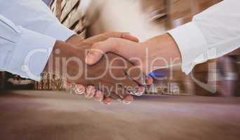 Composite image of close-up shot of a handshake in office