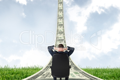 Composite image of businessman sitting in swivel chair