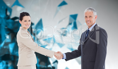 Composite image of smiling business people shaking hands while l