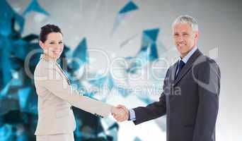 Composite image of smiling business people shaking hands while l