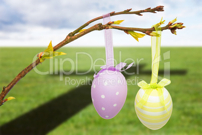 Composite image of hanging easter eggs