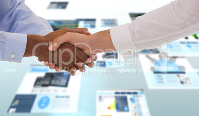 Composite image of close-up shot of a handshake in office