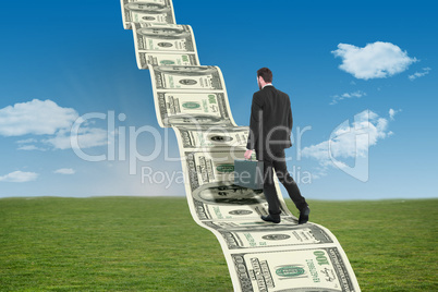 Composite image of businessman walking while holding briefcase