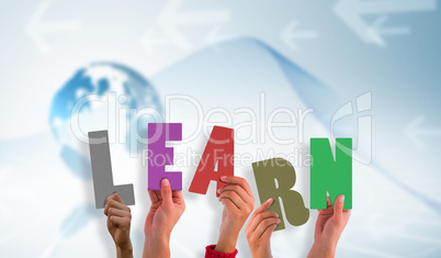 Composite image of hands holding up learn Composite image of hands holding up learn