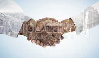 Composite image of close-up shot of a handshake in office