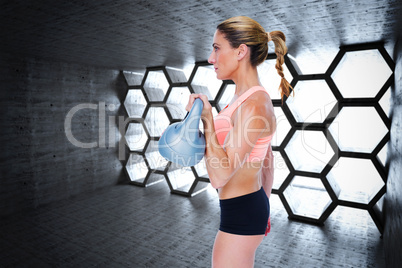 Composite image of female blonde crossfitter lifting kettlebell