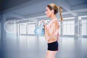 Composite image of female blonde crossfitter lifting kettlebell