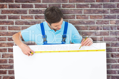Composite image of carpenter measuring blank bill board