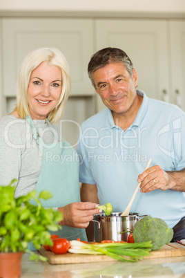 Happy mature couple making dinner together