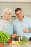 Happy mature couple making dinner together