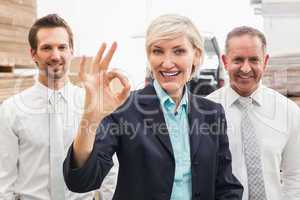 Smiling warehouse manager making okay gesture