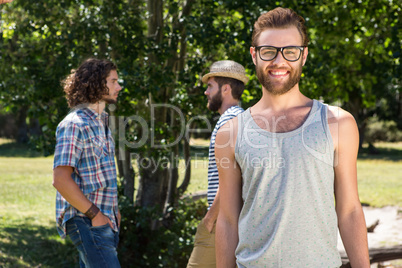 Hipster smiling at camera in the park