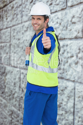Composite image of portrait of happy man showing thumbs up