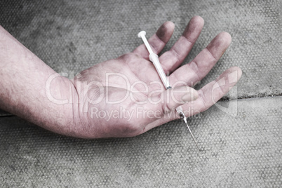 Man injecting himself with a small hypodermic