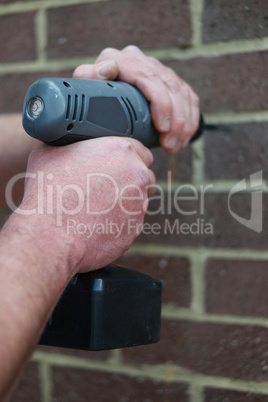 Man using a battery operated hand drill