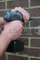 Man using a battery operated hand drill