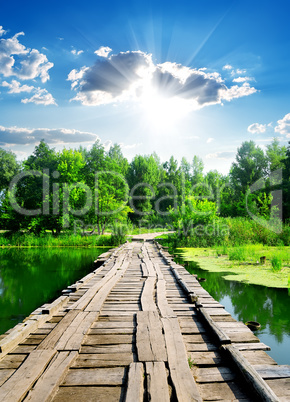 Sun over wooden bridge