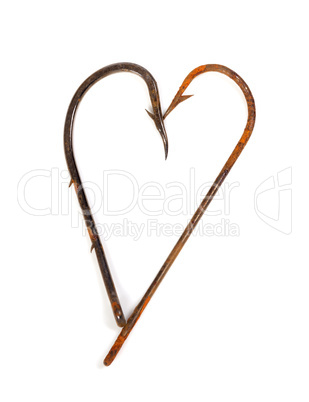 Old rusty fish hooks in form of heart