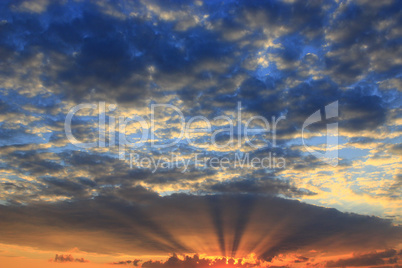 beautiful summer sunset with dark sky and sun