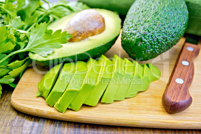 Avocado slices on board with knife