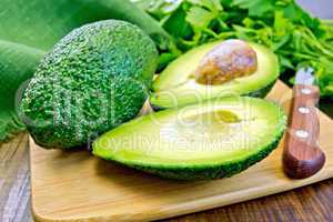 Avocado with parsley on board