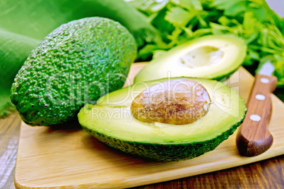 Avocado with napkin on board