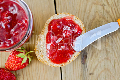 Bread with strawberry jam and berries on board