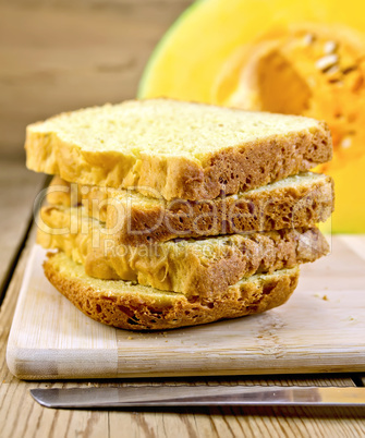 Bread pumpkin homemade slices with knife on board