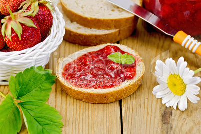 Bread with strawberry jam and chamomile on board